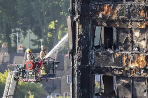 PA Firefighters spraying water on Grenfell Tower