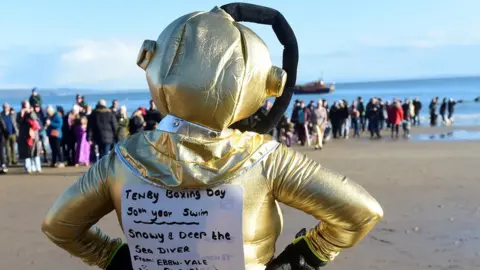 Reuters person in fancy dress on beach