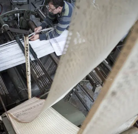 Tim Smith Peter Moore setting up a loom at Francis Moore Specialist Weavers in Halifax