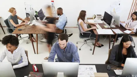 Getty Images People working in an open plan office
