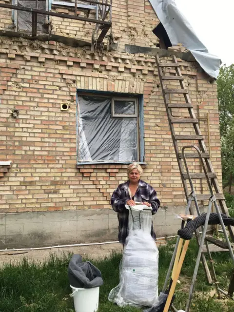 Shelterbox Woman outside house