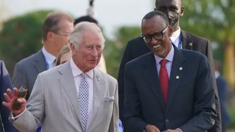 PA Media The Prince of Wales (left) walks with Rwanda President Paul Kagame