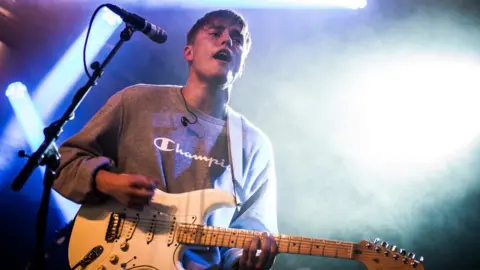 Getty Images Sam Fender on stage