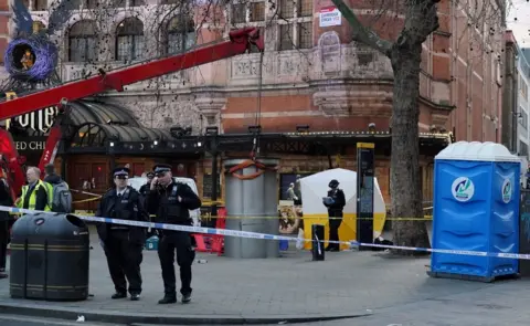 PA Media A police tent is erected at Cambridge Circus on the junction between Shaftesbury Avenue and Charing Cross Road in London, after a man died after being crushed by a telescopic urinal