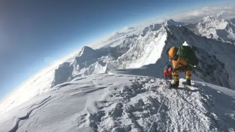 Getty Images Everest climbers trek to the summit of the world's highest mountain