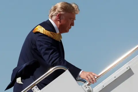 Tom Brenner/Reuters Money is seen in the back pocket of U.S. President Donald Trump as he boards Air Force One at Moffett Federal Airfield in California, USA. 17 September 2019.