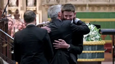 PA Media Dad David Webber hugging his son Charlie Webber