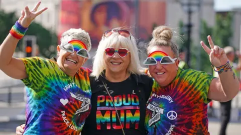 PA Media Three women at Liverpool Pride
