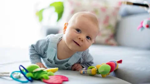 Getty Images Baby playing on his tummy