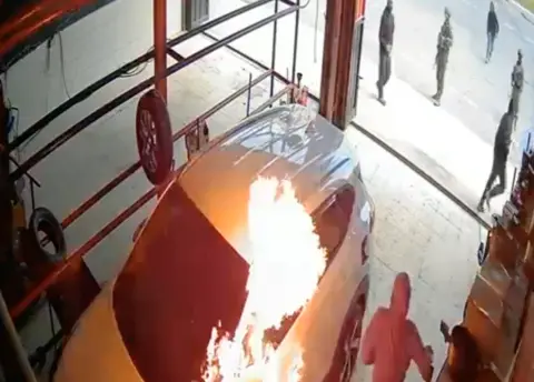 Yesh Din Screengrab of a video shared by Yesh Din, an Israeli human rights group, shows a car being set on fire during an attack by Israeli settlers on the Palestinian village of Dayr Dibwan while Israeli soldiers stand watching