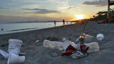 Getty Images Plastic cups used by tourists on the Aegean sea beach near Athens, Greece