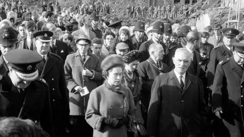 PA The Queen on the site of Pantglas Junior School, on her right is Councillor Jim Williams, who lost seven members of his family