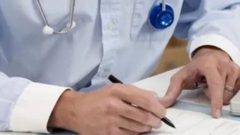 Science Photo Library  generic doctor holding pen