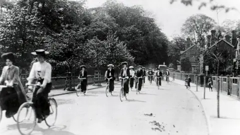 The Bournville Society Cadbury employees cycling to work along Bournville Lane in 1905