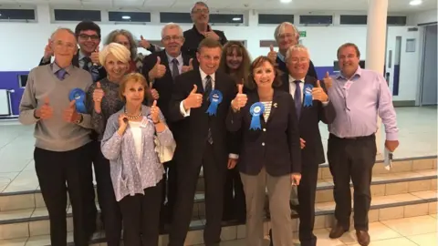 Janet Finch-Saunders David Jones celebrates with his team after retaining Clwyd West