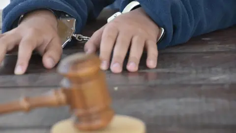 Getty Images A child in handcuffs (file)