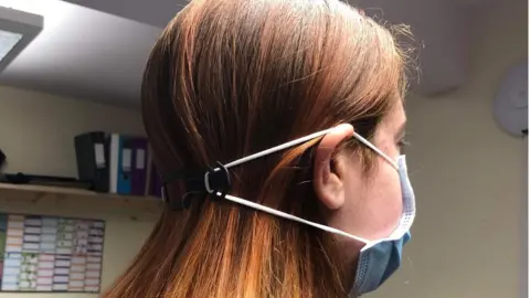 Debbie Harvey One of the mask adjusters worn by a health worker at Audley St George's Place Retirement Village