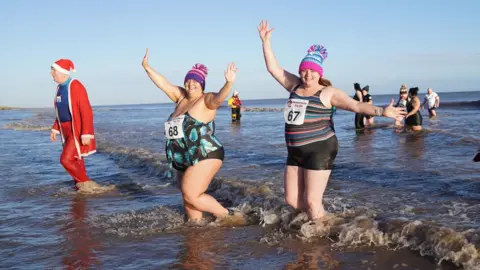 PA Media People take part in the New Year's day Mablethorpe Big Dip in Lincolnshire