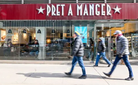 Getty Images People walking past a Pret A Manger branch in New York in February of this year