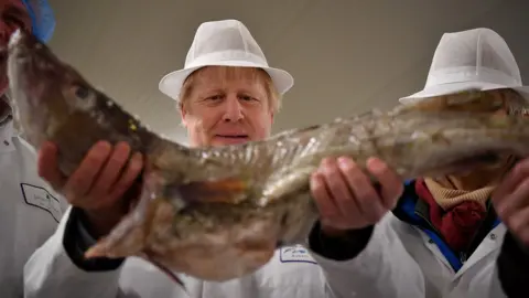 Reuters Boris Johnson holding a fish