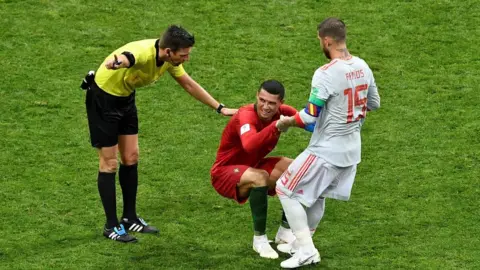 AFP/Getty Ramos helps Ronaldo up