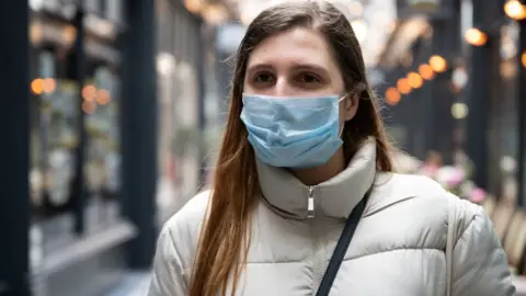 Empics A woman wearing a face mask