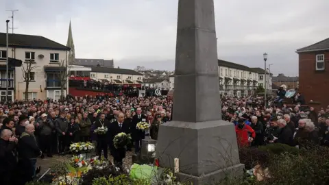 Brian Lawless/PA Wreaths are placed at the Bloody Sunday memorial during an event to mark the 50th anniversary