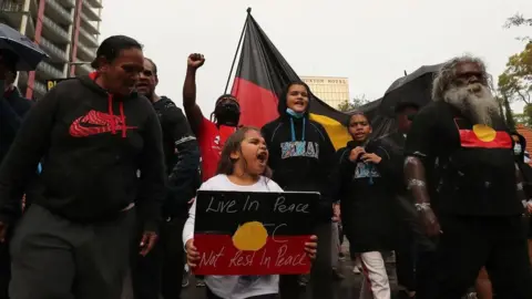 Getty Images Protesters march down St Georges Terrace following a Black Lives Matter rally at Langley Park on June 13, 2020 in Perth, Australia