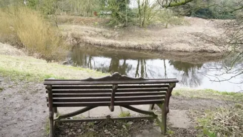 PA Media bench by the river Wyre