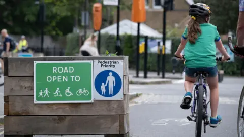 Getty Images A young cyclist passes through the barriers that form an LTN (Low Traffic Neighbourhood),