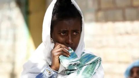 Getty Images Tigray people stage a protest against the government on the distribution Condition of food and on the current situation of Tigray that internally displaced people taking shelter on Hawelti Secondary School in Mekele city Tigray on March 8, 2021.