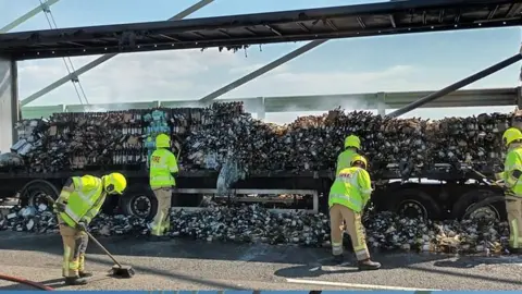 National Highways Firefighters cleared up the wine bottles after extinguishing the fire