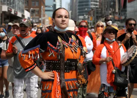 Carlos Osorio / Reuters Indigenous performer Danielle Migwans attends a march on Canada Day in Toronto, Ontario
