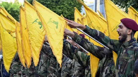 Hezbollah fighters attend the funeral of commander in Beirut on 23 September 2024