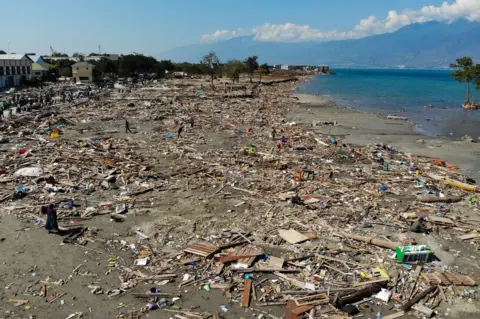 Getty Images Debris litters the beach in Palu, Indonesia