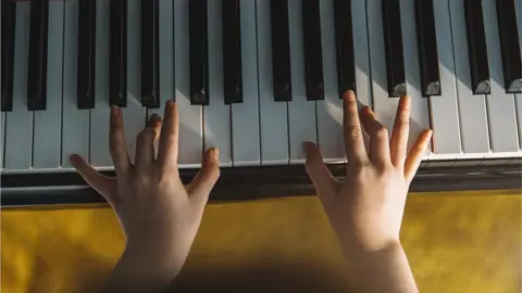 Getty Images Hands playing the piano