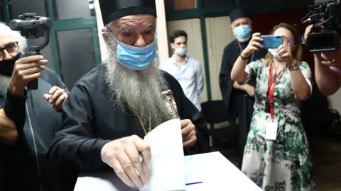 Reuters Metropolitan Amfilohije, the Serbian Orthodox Church's top cleric in Montenegro, casts his ballot