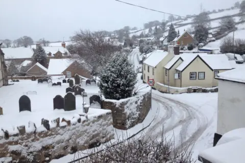 Sue Pinney Houses covered in snow