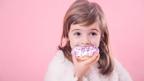 Getty Images Child eating cake