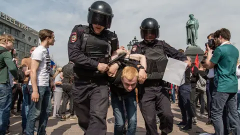 Getty Images Russian Police forces seen arresting a protester during a demonstration in Moscow's Pushkin Square