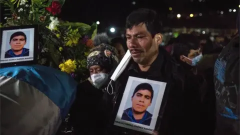 EPA Friends and relatives of the murdered migrants cry as they receive the bodies of their loved ones, in Comitancillo, Guatemala 12 March 2021.
