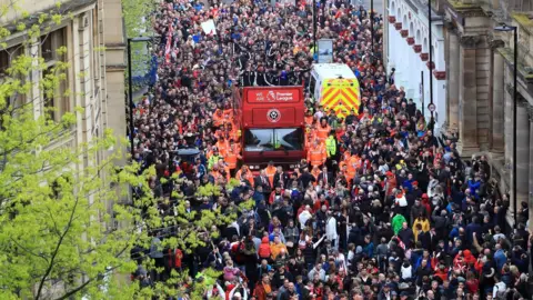 Danny Lawson/PA The Sheffield United players and manager Chris Wilder wave to the fans during the promotion parade in Sheffield city centre
