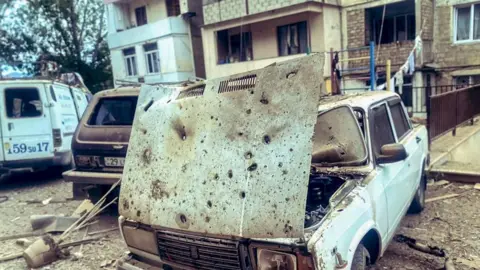 SARGSYAN/OC MEDIA/EPA-EFE/REX/Shutterstock A handout photo made available by OC Media shows damage to residential buildings and vehicles in Stepanakert, Nagorno-Karabakh