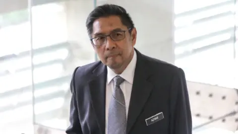 EPA MH370 Response Team leader Azharuddin Abdul Rahman arrives at the ministry of transport headquarters in Putrajaya, Malaysia, 30 July 2018