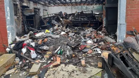 Middlesbrough Council Burnt out building with rubble and dumped items