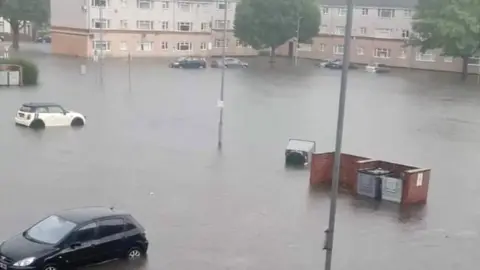 Sarah Parker A car park outside a block of flats flooded in Worksop