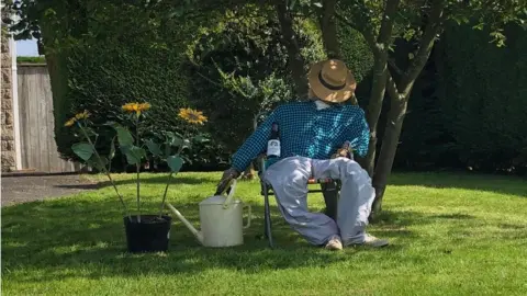 Carole Dent Scarecrow asleep under tree