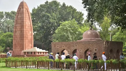 Getty Images Visitors at the Jallianwala Bagh memorial after its reopening, on August 29, 2021 in Amritsar, India.