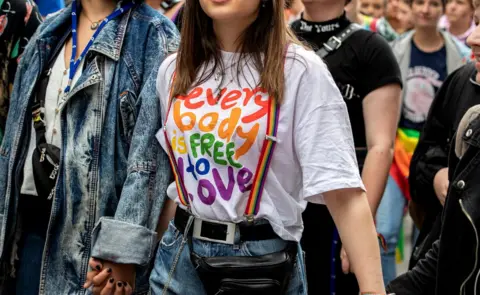 Getty Images A woman at a gay pride march in Munich wears a T-shirt reading "everybody is free to love", 13 July 2019