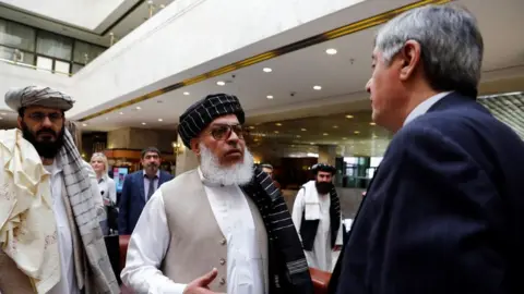 Getty Images May 2019: Representatives of Taliban chat with Russian presidential envoy to Afghanistan, Zamir Kabulov (R)